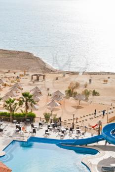 resort sand beach on Dead Sea coast in Jordan