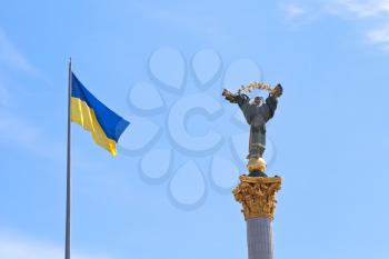 ukrainian flag and Monument to Berehynia in Kiev, Ukraine