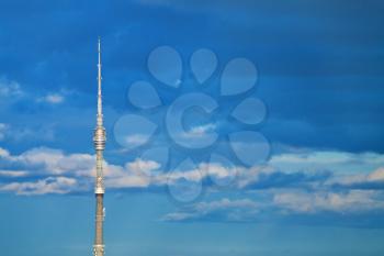television tower with deep blue cloudy afternoon sky background