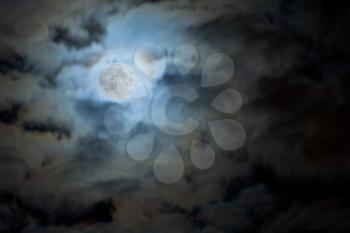 full moon in night clouds on sky