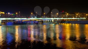 night illumination of Novoarbatsky bridge through Moskva River in Moscow, Russia