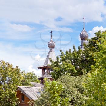 wooden church in green garden under blue sky