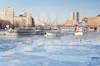 iceboats and fisherman on frozen Moscow river in sunny winter day