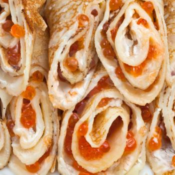 pancakes rolls with red caviar close up