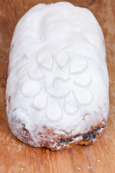 Stollen cake with dried fruit and marzipan and covered with powdered sugar