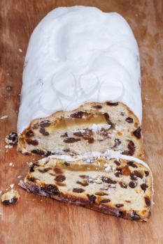 sliced Stollen cake with dried fruit and marzipan and covered with powdered sugar