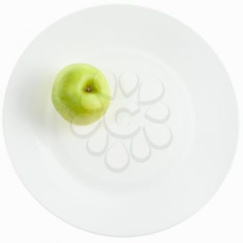 yellow green apple on white plate isolated on white background