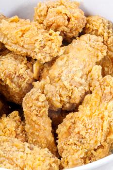 hot fried chicken wings in basket close up