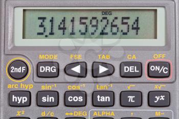 number pi on display of scientific calculator with mathematical functions close up