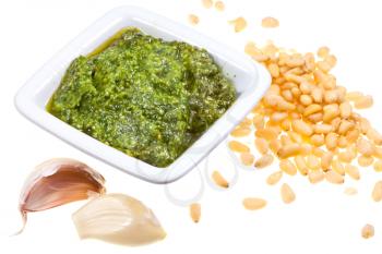italian pesto sauce with pine nuts and garlic cloves isolated on white background