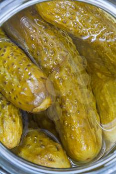 top view on salted cucumbers in glass jar close up