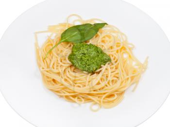 spaghetti with pesto on plate isolated on white background