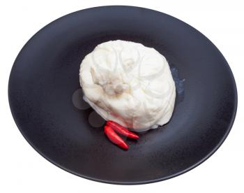 fresh italian cheese burrata and red pepper on black ceramic plate isolated on white background