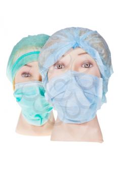 two female manikin doctor heads wearing textile surgical cap and medical protective mask isolated on white background
