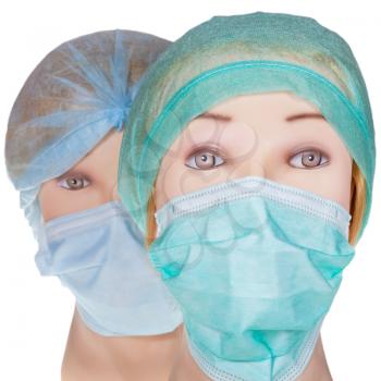 female dummy doctor heads wearing textile surgical cap and medical protective mask isolated on white background