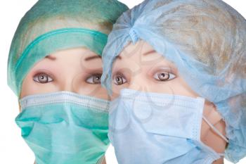 two female dummy doctor heads wearing textile surgical cap and medical protective mask close up