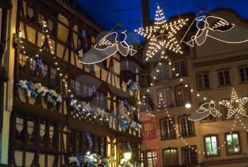 electric christmas garlands in medieval european town at night