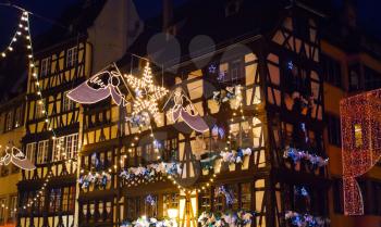 electric christmas garlands in medieval european town at night