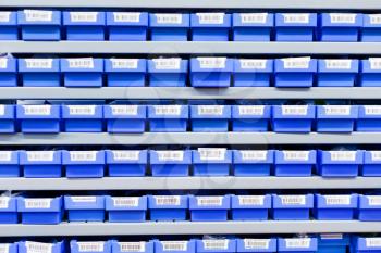 blue plastic boxes in storage stand