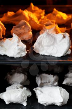 preparing of sweet dessert meringue on oven trays close up