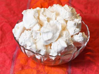 meringue sweet dessert from whipped egg whites and sugar on red cloth