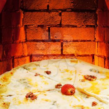 italian pizza quatro formaggi and hot brick wall of wood burning oven