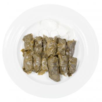 top view of portion armenian meal - dolma from grape leaves and mince on plate isolated on white background