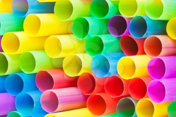 many ends of multicoloured plastic drinking straws close up