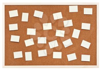 many small sheets of paper on bulletin cork board isolated on white background