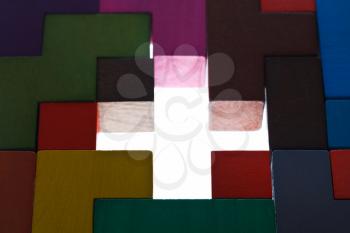 illuminated cross shape hole in wooden multicoloured puzzle