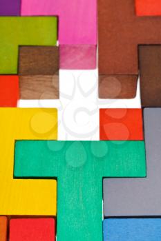 cross shape hole in wooden multicoloured puzzle