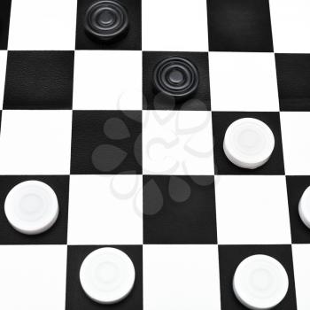 playing position on black and white checked draughts board