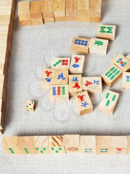 above view of playing field of mahjong board game on textile table