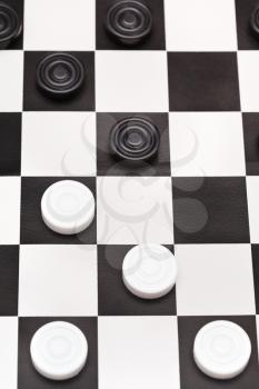 above view of playing position on black and white draughts board