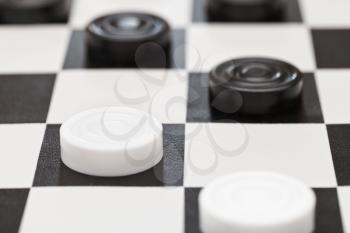 draughts on black and white vinyl board close up