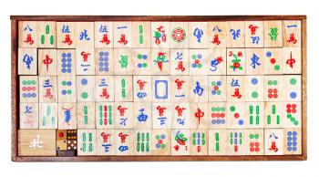 top view of set of wooden mahjong game tiles in box isolated on white background