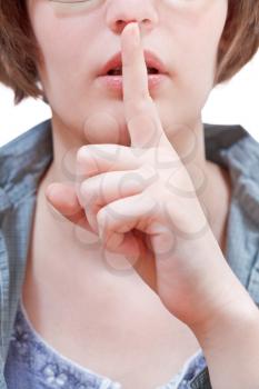 front view of finger near lips - silence hand gesture isolated on white background
