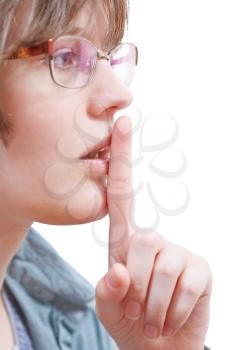 forefinger near lips - silence hand gesture isolated on white background
