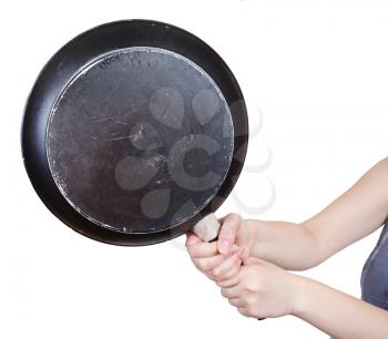 black frying pan in female hands close up isolated on white background