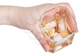 whiskey on ice in glass in hand isolated on white background