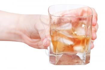 hand holds whiskey on ice in glass isolated on white background