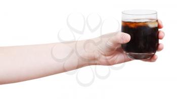 hand holds soft drink with ice in glass isolated on white background
