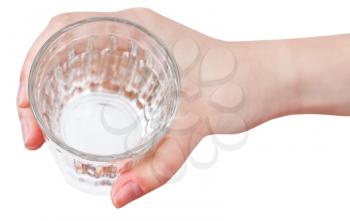 above view of hand holding natural water in glass isolated on white background