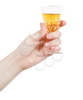 hand holds little glass of dessert wine isolated on white background
