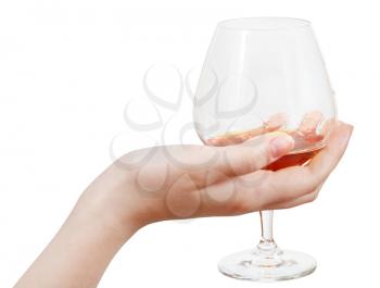 glass goblet with brandy in hand isolated on white background