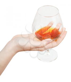 hand holds glass with brandy isolated on white background