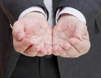 front view of businessman handful from two palms - hand gesture close up