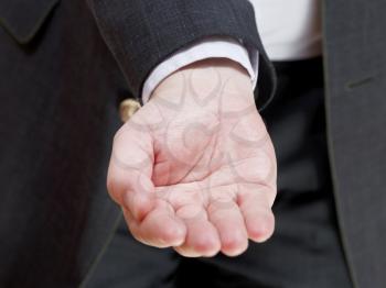 businessman holds empty handful - hand gesture