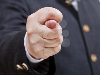 businessman holds fig sign close up - hand gesture