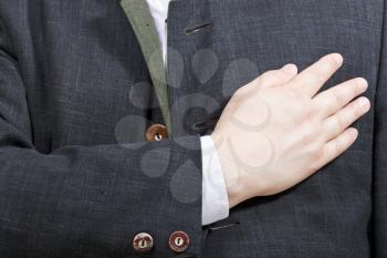 businessman holding his hand on his chest - hand gesture isolated on white background